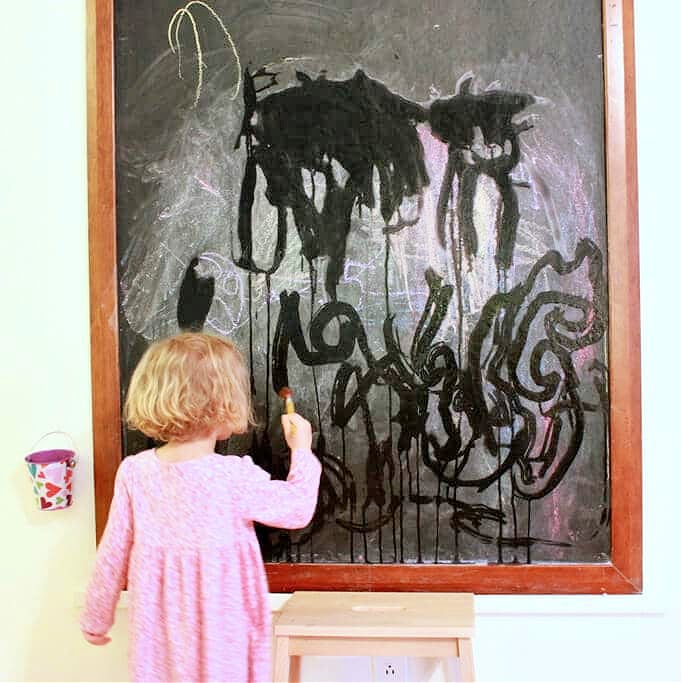 painting with water on a chalkboard