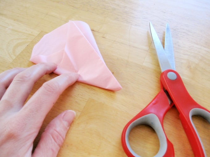 folded tissue paper and scissors