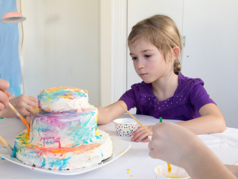 girl painting a cake