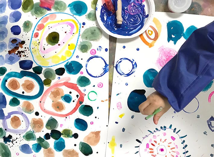 Child painting colorful circles and dots for Yayoi Kusama Inspired Dot-Paintings