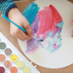 child painting with watercolors