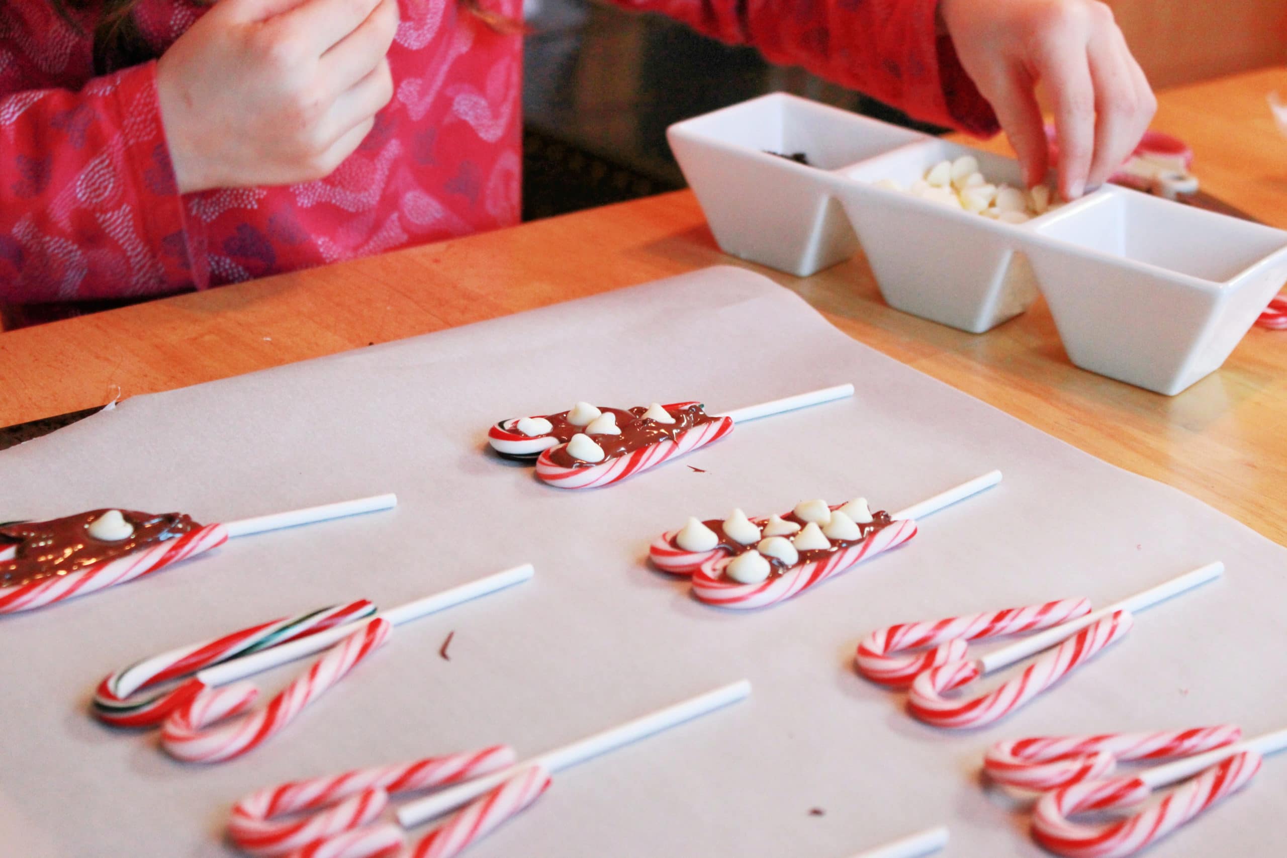 adding decorations to candy cane hearts