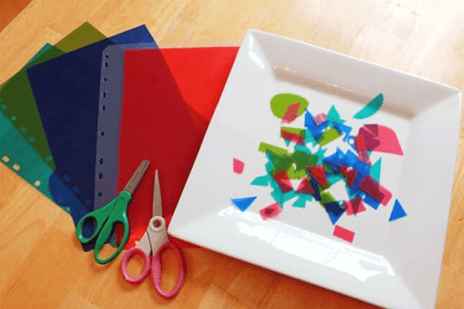 Suncatcher craft materials – scissors and cut pieces of index dividers