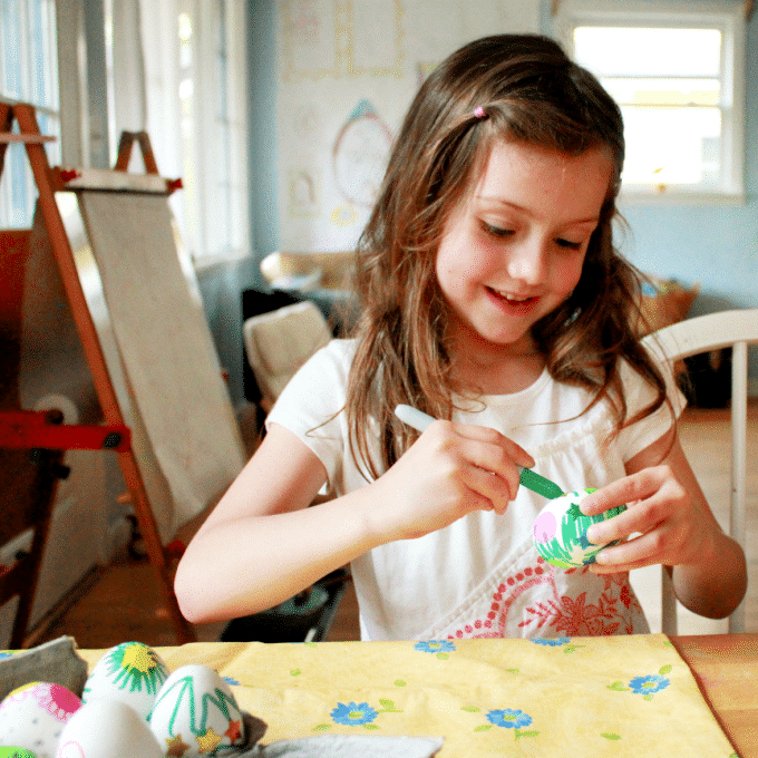girl decorating egg with sharpie