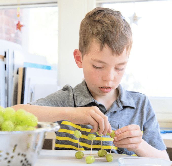 boy building with grapes