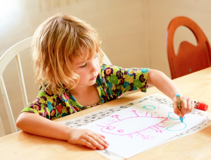 child drawing on paper