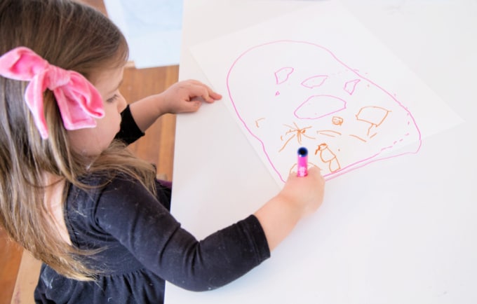 girl drawing with marker