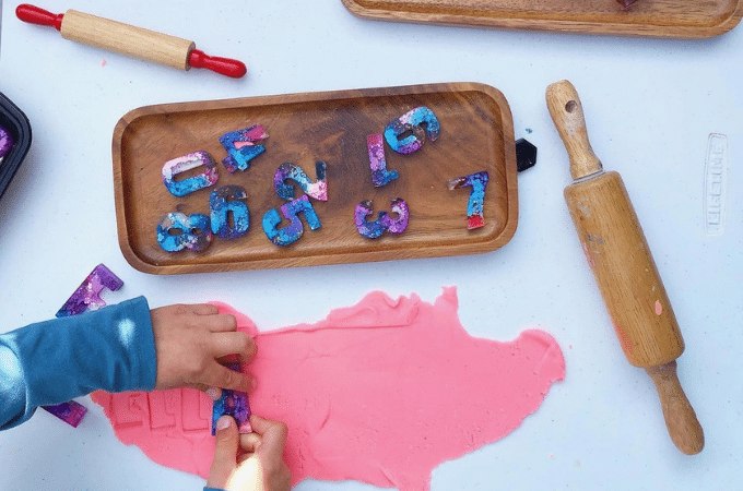 pressing letters into clay