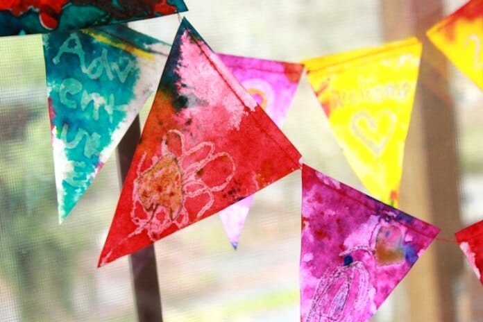 Buntings with melted crayon drawings, water color paint, and vegetable oil giving the overall look of a stained glass bunting.