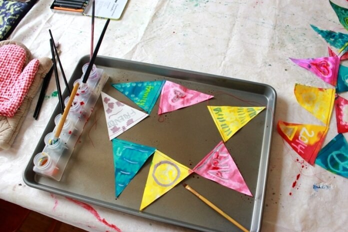 Paper buntings with melted crayon drawings and painted with water color.
