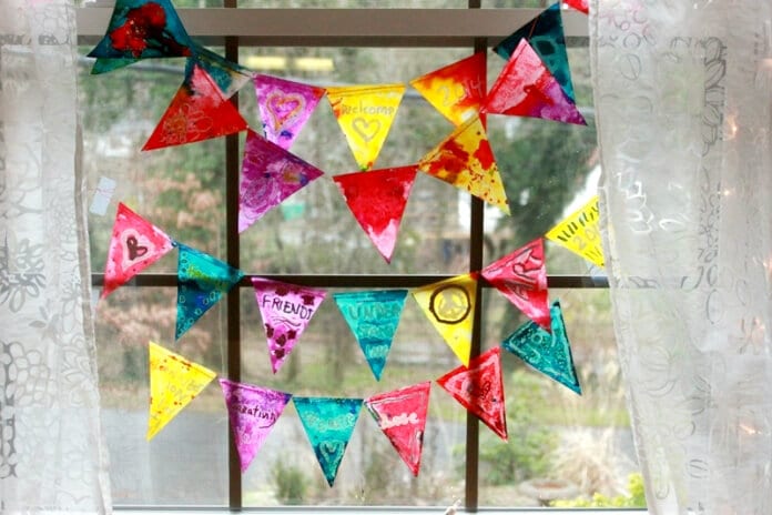 Beautifully made melted crayon stained glass buntings hanging in the window.