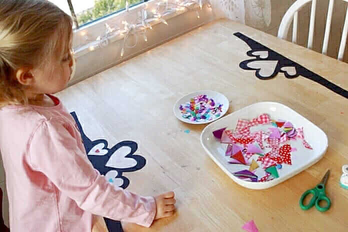 Decorating heart crowns with tissue paper hearts