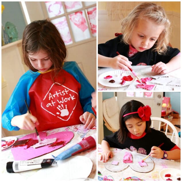 Kids painting the cardboard heart art