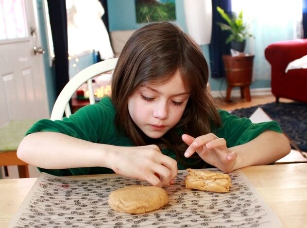 child playing with peanut butter playdough