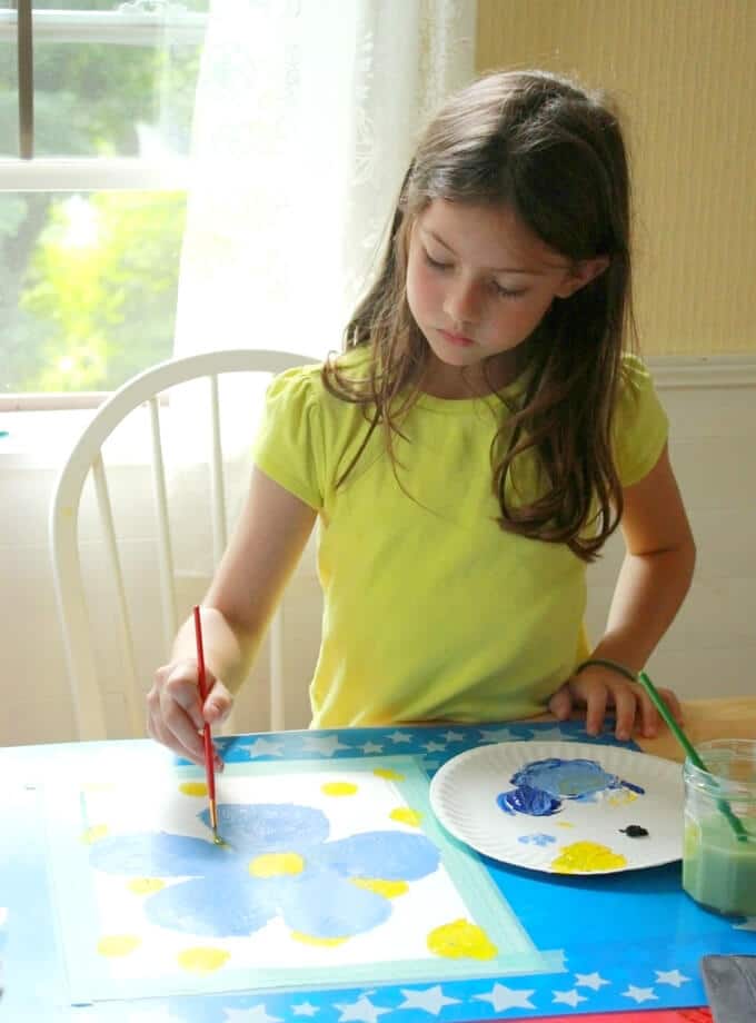 Maia painting her flower