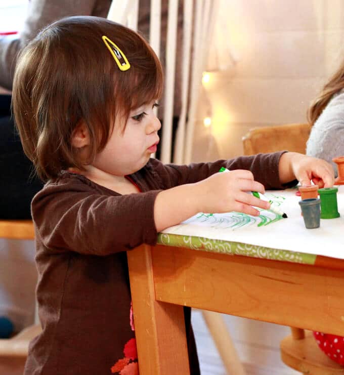 Photo of a toddler drawing at a low table
