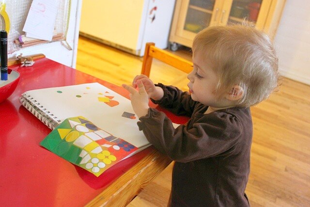Toddler Making a Sticker Collage