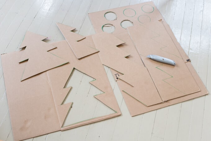 Cutting out the Christmas tree shapes from cardboard