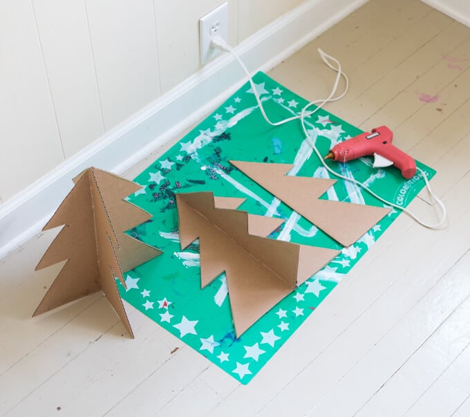 Gluing the cardboard Christmas trees together
