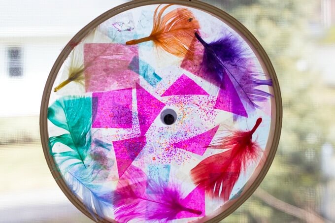 Tissue paper suncatchers with feathers and glitter