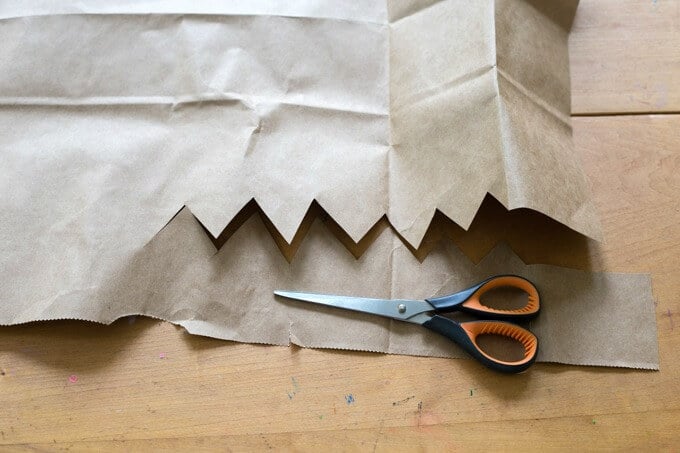 Cutting a Brown Paper Grocery Bag into diy crowns.