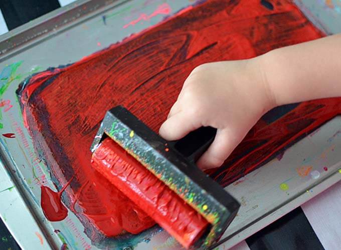 Rolling paint on a gelatin plate with a brayer