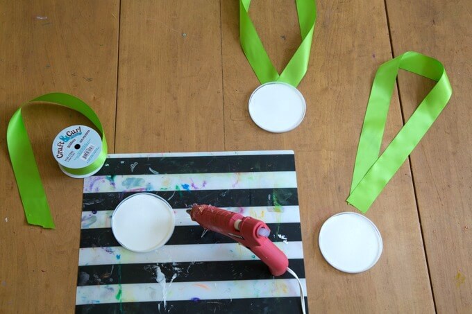 DIY Olympic Medals for Kids - Glue the paper circles to the lids