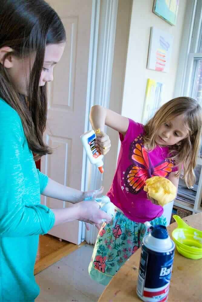 children adding glue to slime
