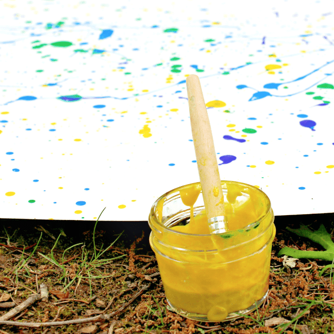 jar of yellow paint and splatter painting
