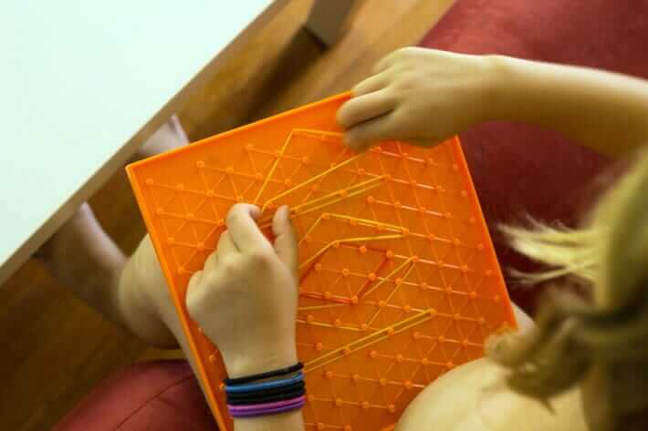 Making geoboard art with rubber bands