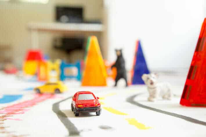 Cars and figurines on the DIY play mat