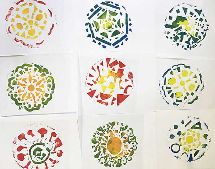 Finished mandala pizza prints made by kids using collograph printing plates