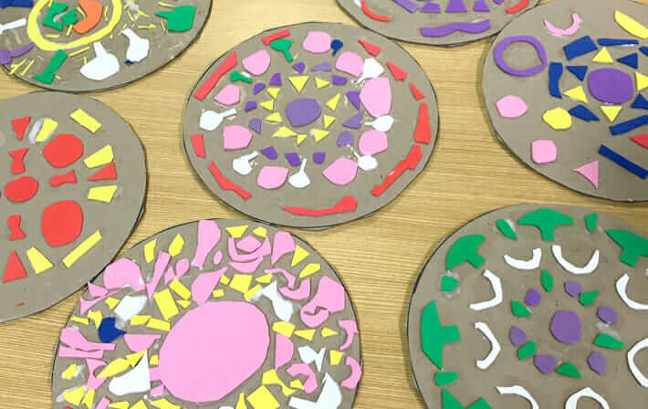 Making mandala pizza designs on cardboard circles for an easy printmaking idea kids can do themselves