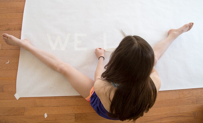 Writing words with tape for tape resist art