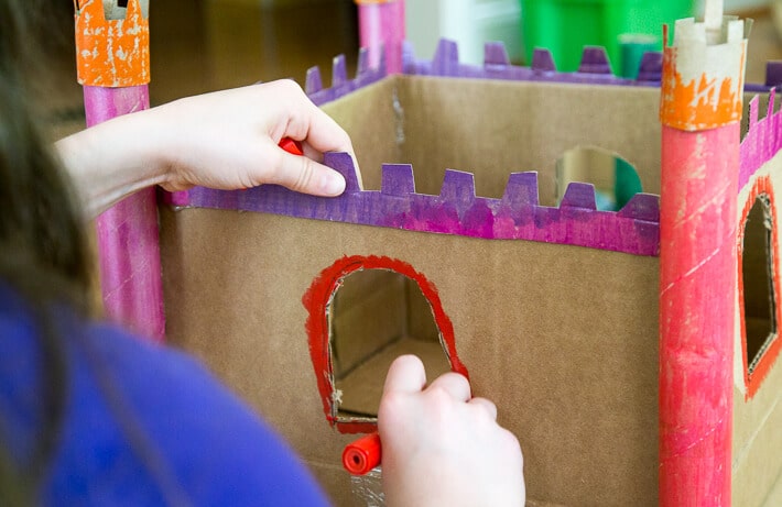 Coloring cardboard castle with paint sticks