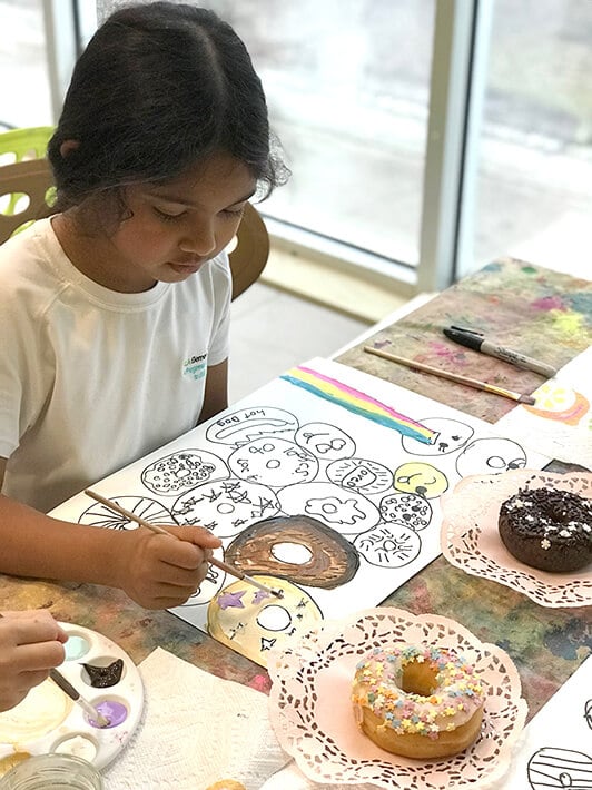 Girl painting donuts - observational drawing for kids