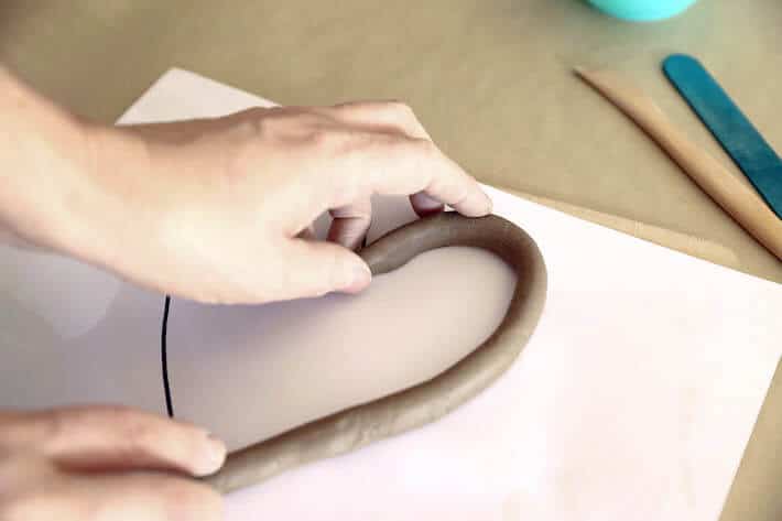 Placing Clay Coil on Heart Drawing