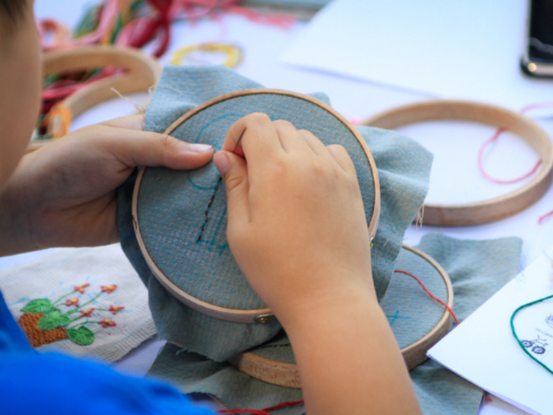 child sewing