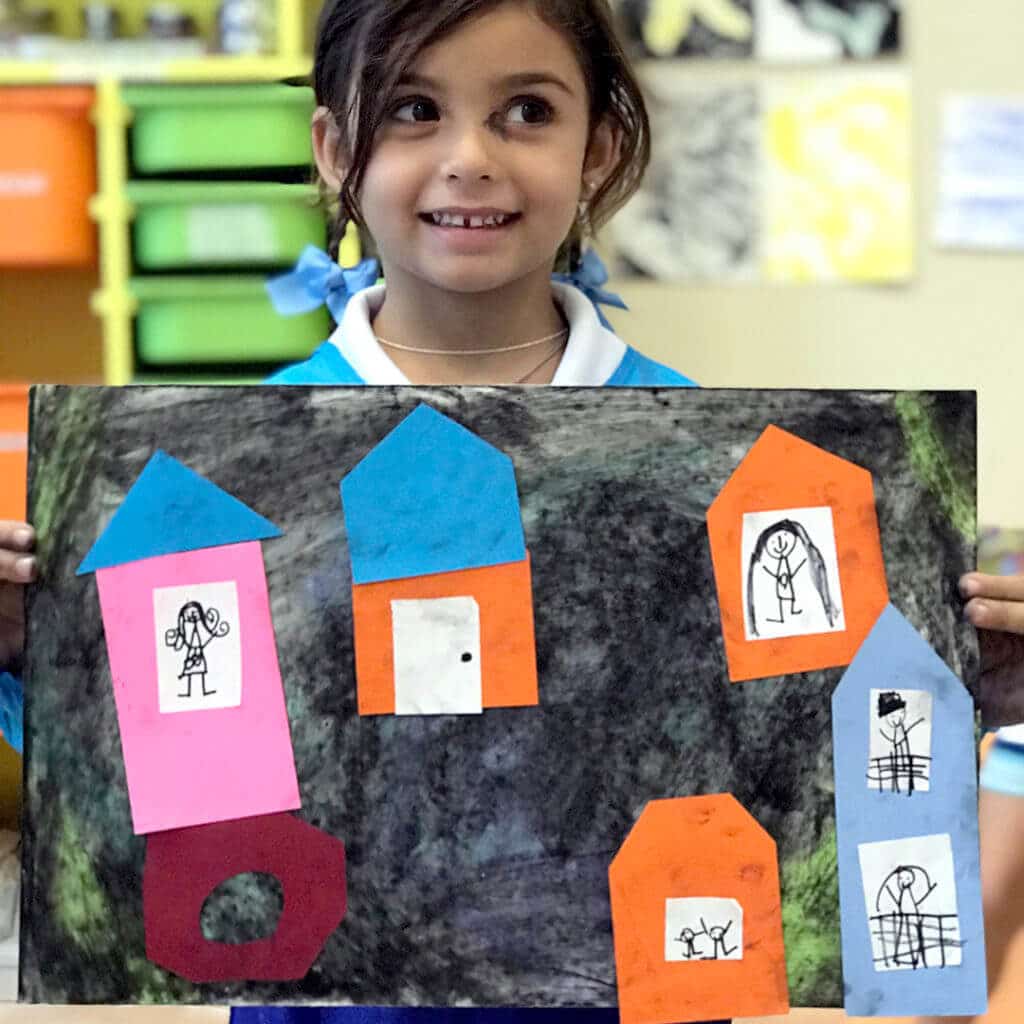 Girl holding mixed media collage of city – Paul Klee Art for Kids