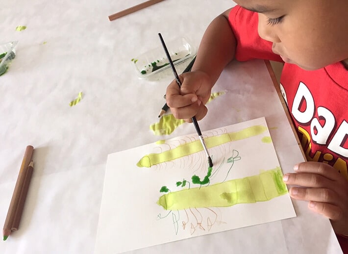 Child painting for nature inspired art project