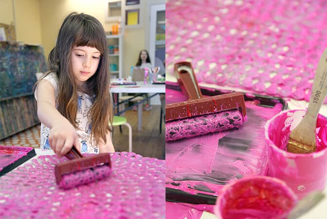 Girl rolling brayer on bath mat | bath mat printmaking activity
