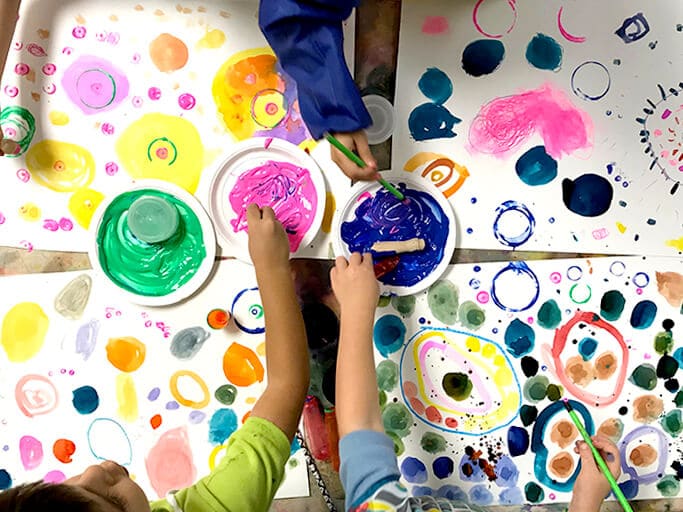Children painting colorful circles and dots for Yayoi Kusama Inspired Dot Paintings for Kids