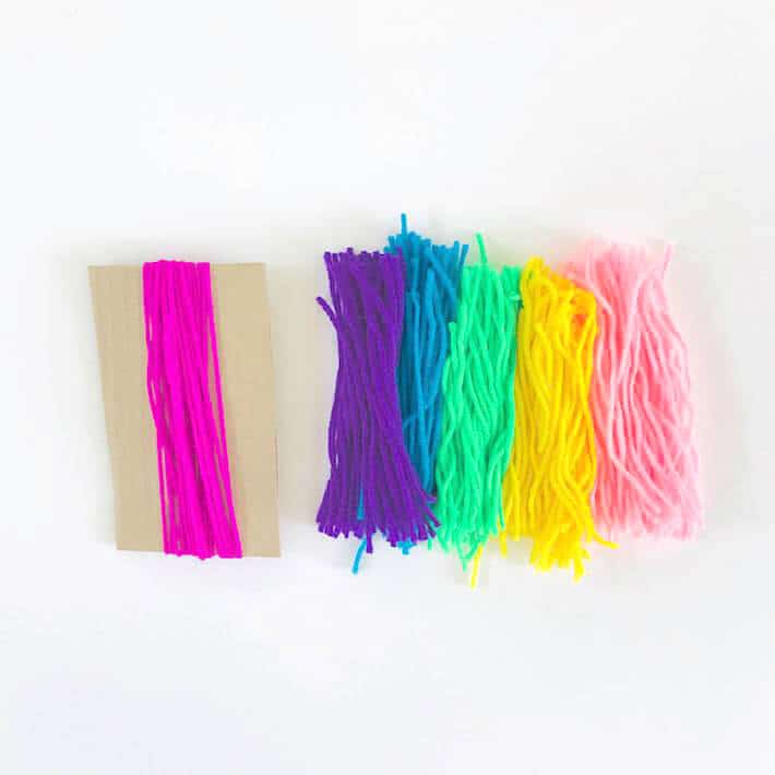 Cut pieces of brighly colored yarn