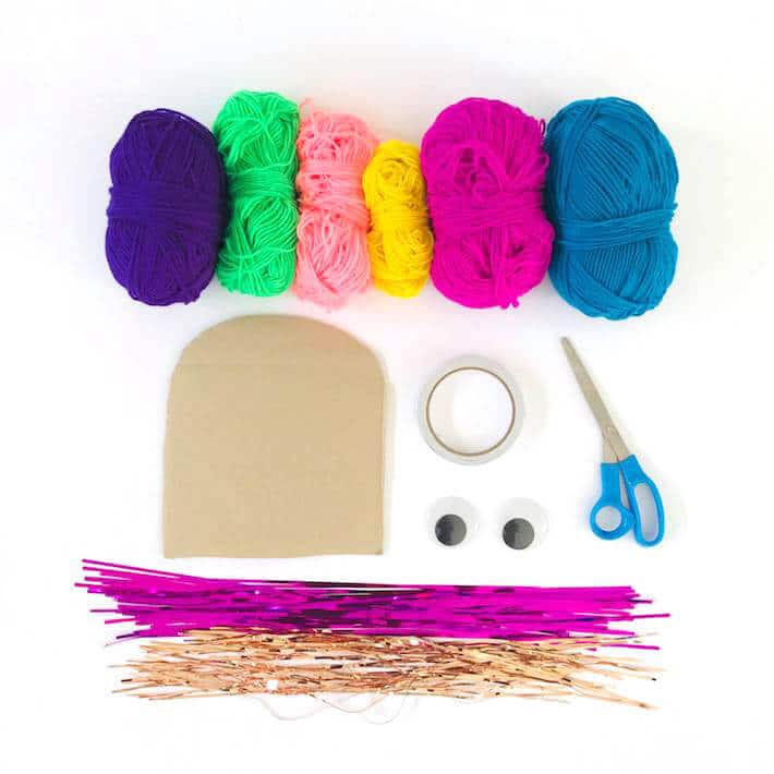 Materials for creating wooly monster yarn wall hanging