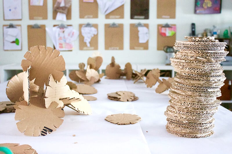 Stack of cardboard building discs along with an assembled cardboard sculpture
