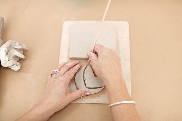 Step 3 – Cutting clay with skewer for clay relief tiles