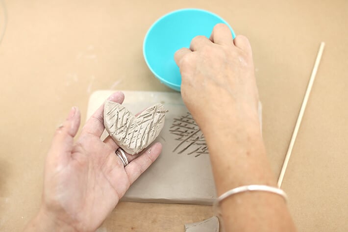 Step 4 – Wetting the piece of clay for clay relief tiles
