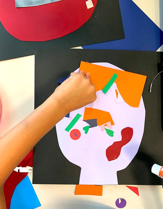 Assembling Picasso collages–self portraits for kids made with cut paper shapes