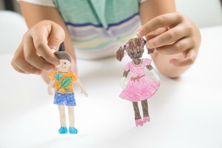 Child Playing with Paper Dolls