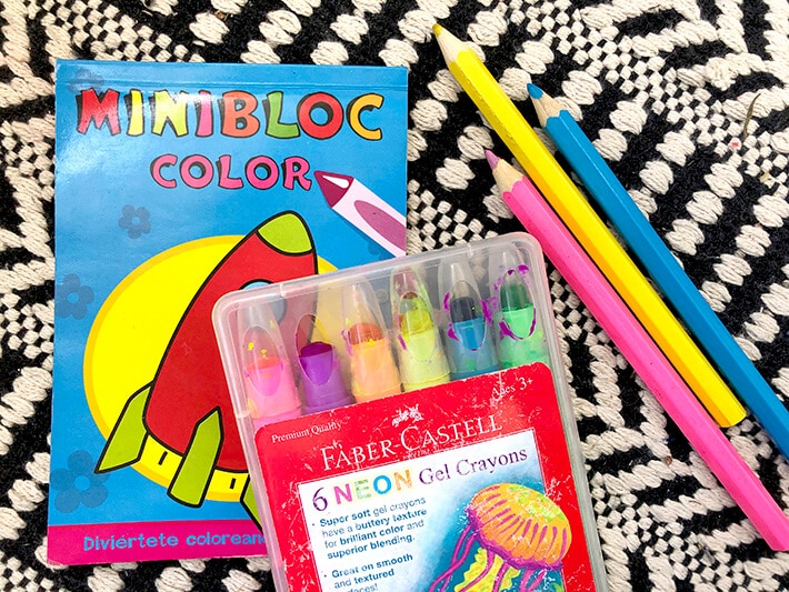 Coloring book, neon gel crayons and colored pencils are great free drawing supplies for traveling with toddlers